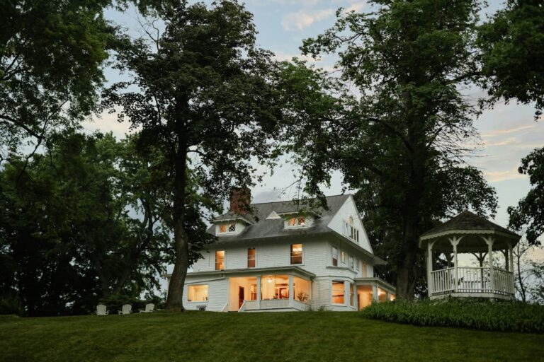 White house with gazebo at dusk.